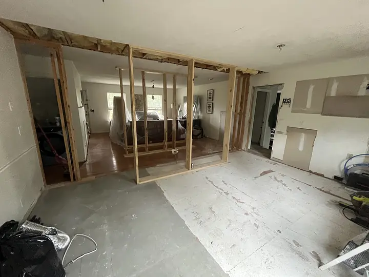 Room under renovation customer wanted kitchen with more room and center bar between kitchen & living room 